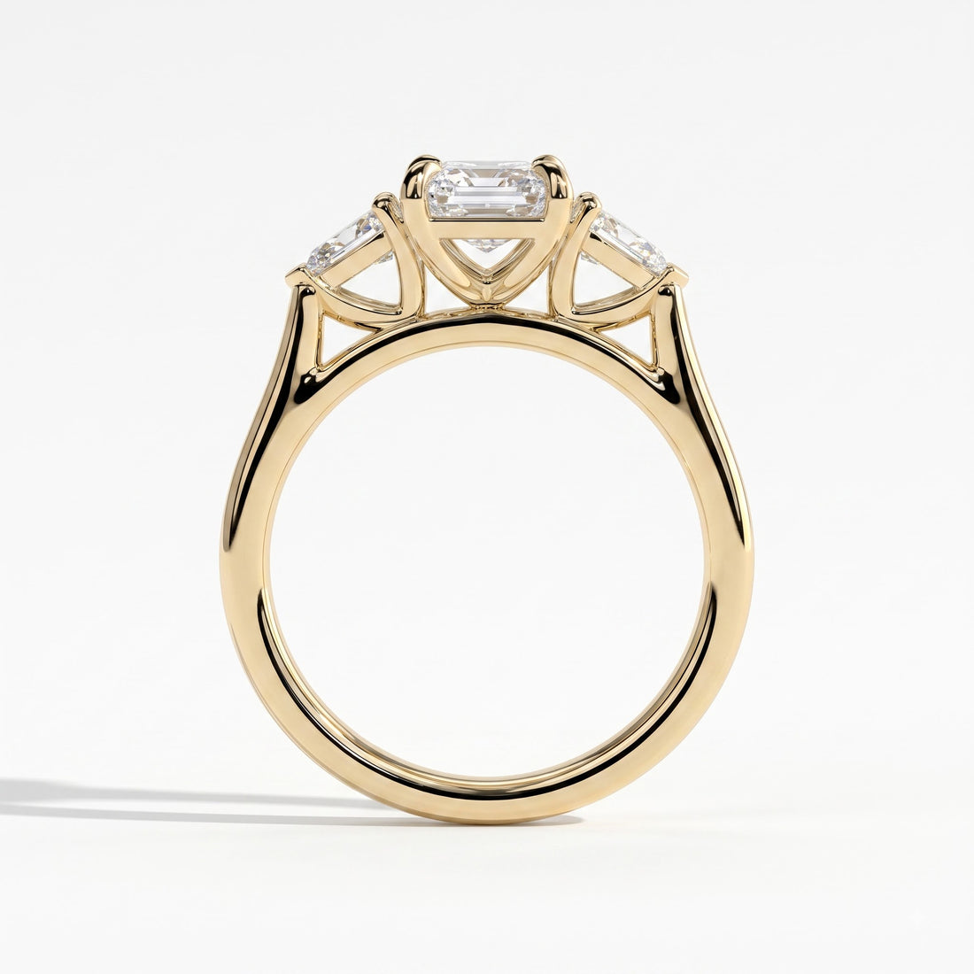 Emerald lab-grown diamond three-stone engagement ring in 14K (585) yellow gold, side profile 