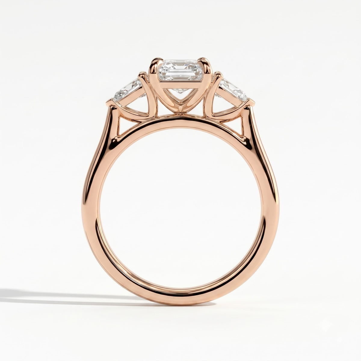 Emerald lab-grown diamond three-stone engagement ring in 18K (750) rose gold, side profile 