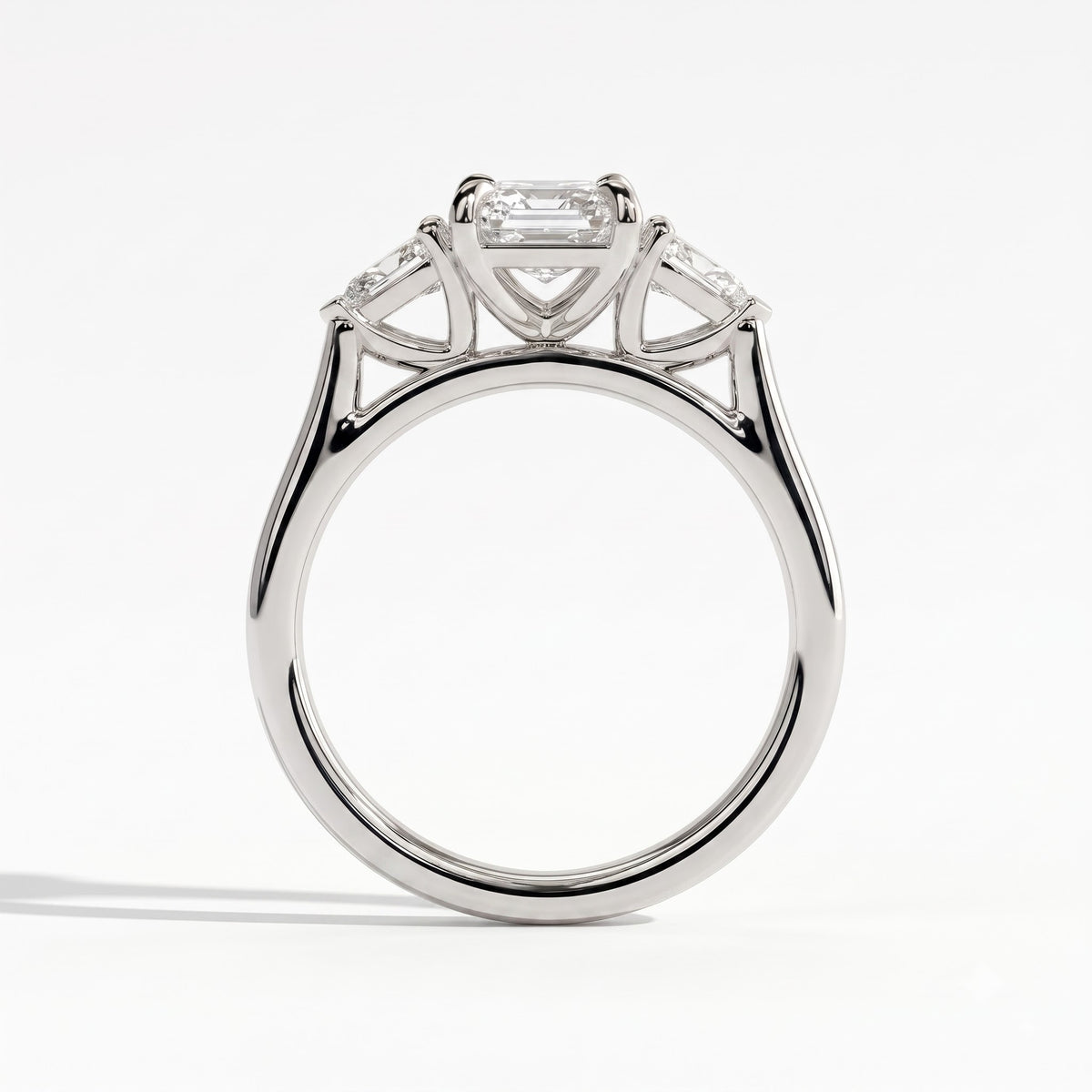 Emerald lab-grown diamond three-stone engagement ring in 950 platinum, side profile 