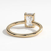 Emerald lab-grown diamond solitaire engagement ring in 18K (750) yellow gold, on white background 
