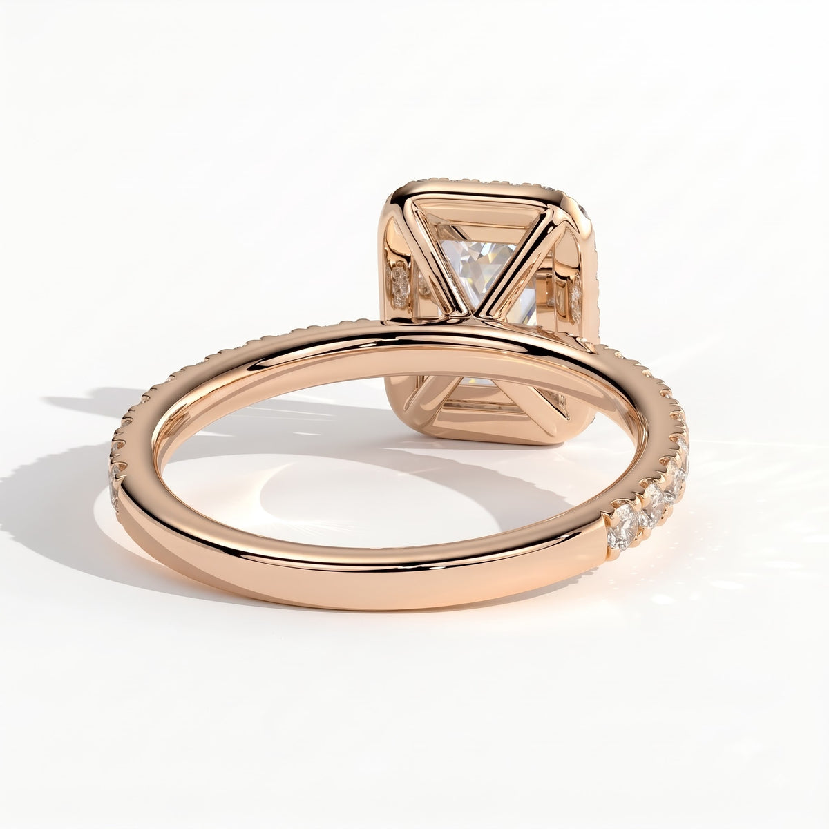 Emerald lab-grown diamond halo engagement ring in 18K (750) rose gold, on white background 