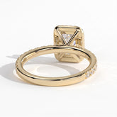 Emerald lab-grown diamond halo engagement ring in 18K (750) yellow gold, on white background 
