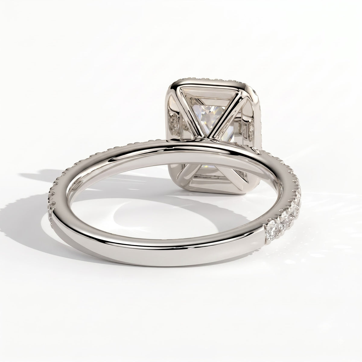 Emerald lab-grown diamond halo engagement ring in 950 platinum, on white background 