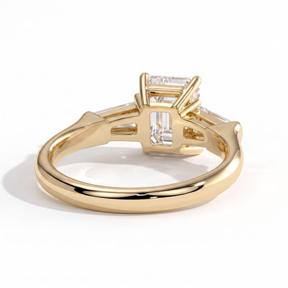 Emerald lab-grown diamond three-stone engagement ring in 14K (585) yellow gold, on white background 