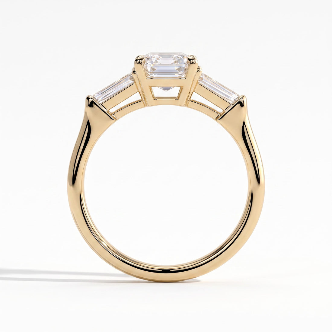 Emerald lab-grown diamond three-stone engagement ring in 14K (585) yellow gold, side profile 