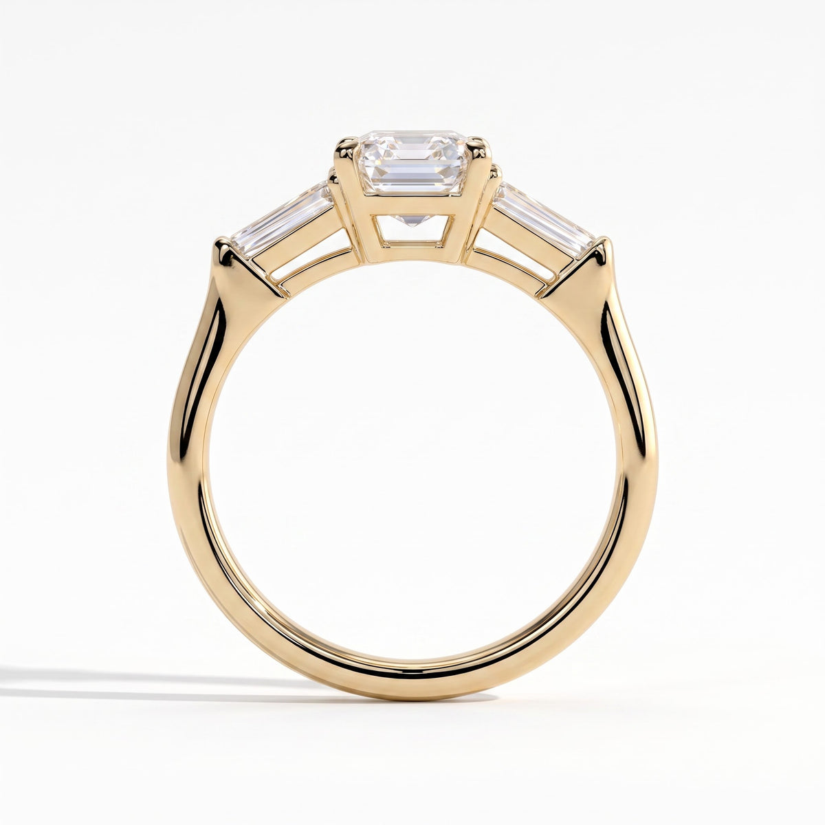 Emerald lab-grown diamond three-stone engagement ring in 14K (585) yellow gold, side profile 