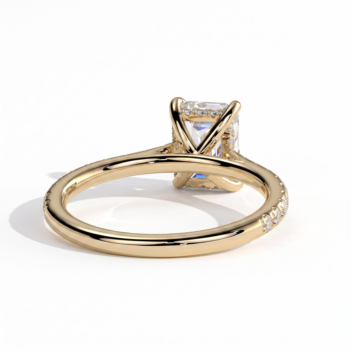Emerald lab-grown diamond halo engagement ring in 14K (585) yellow gold, on white background 