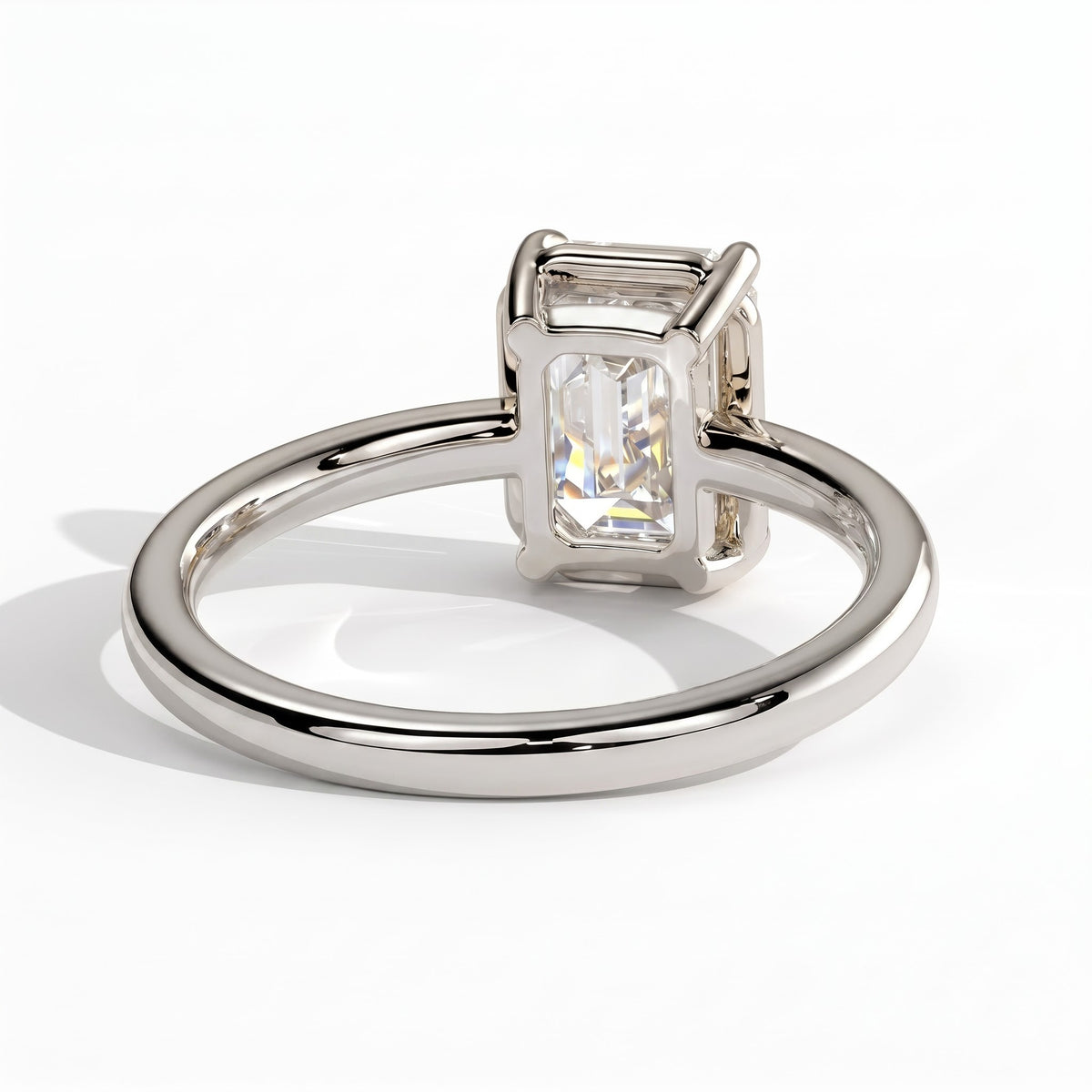 Emerald lab-grown diamond bezel-set solitaire engagement ring in 14K (585) white gold, on white background 