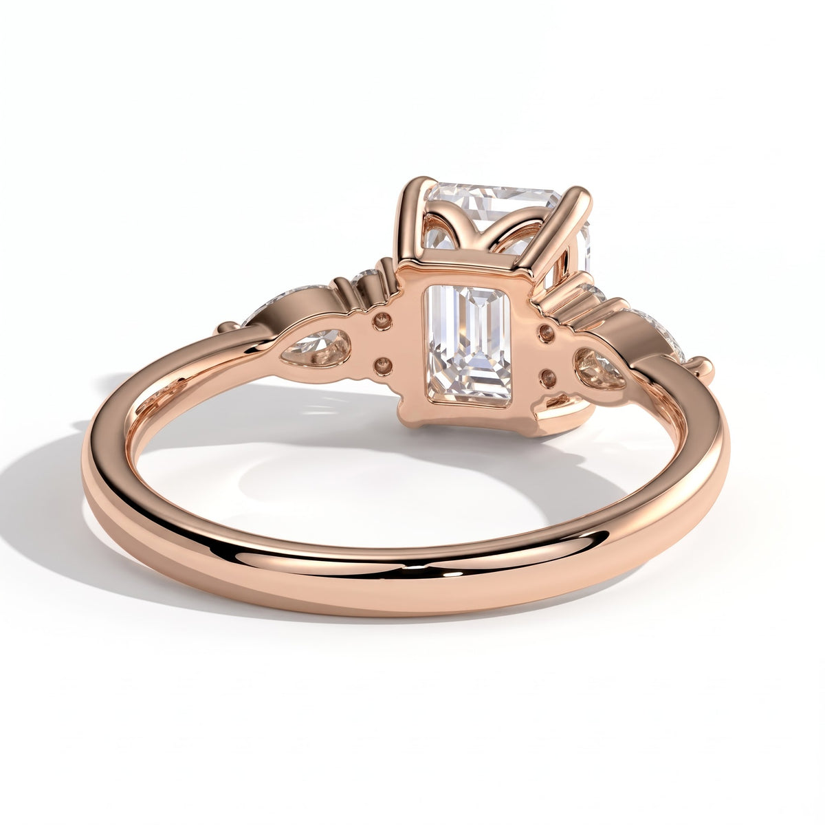 Emerald lab-grown diamond halo engagement ring in 14K (585) rose gold, on white background 