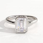 Emerald lab-grown diamond bezel-set halo engagement ring in 18K (750) white gold, front view 
