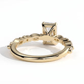 Emerald lab-grown diamond halo engagement ring in 18K (750) yellow gold, on white background 