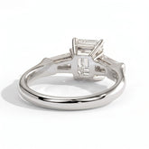 Emerald lab-grown diamond three-stone engagement ring in 18K (750) white gold, on white background 