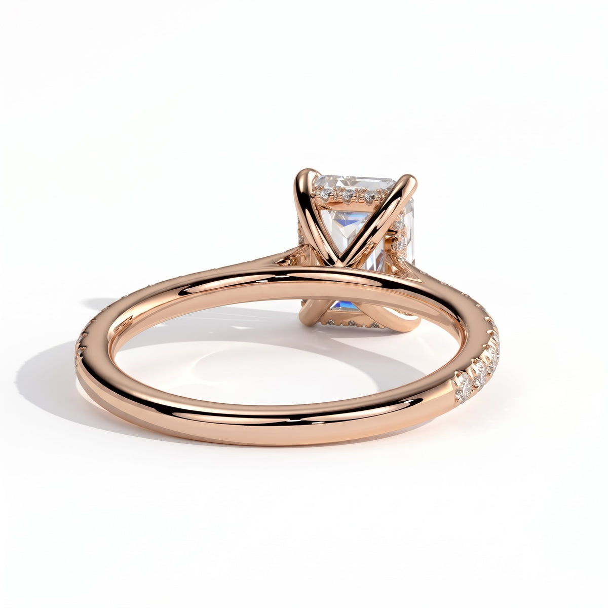 Emerald lab-grown diamond halo engagement ring in 18K (750) rose gold, on white background 