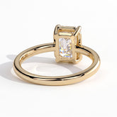 Emerald lab-grown diamond bezel-set solitaire engagement ring in 18K (750) yellow gold, on white background 