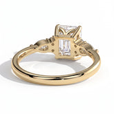 Emerald lab-grown diamond halo engagement ring in 18K (750) yellow gold, on white background 