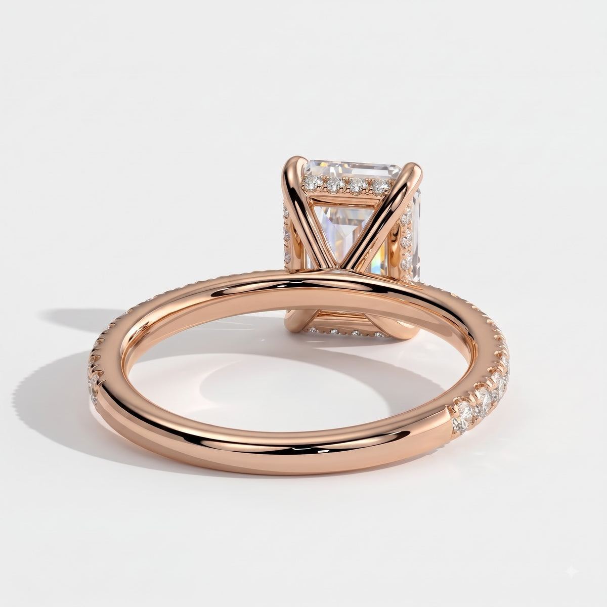 Emerald lab-grown diamond halo engagement ring in 18K (750) rose gold, on white background 