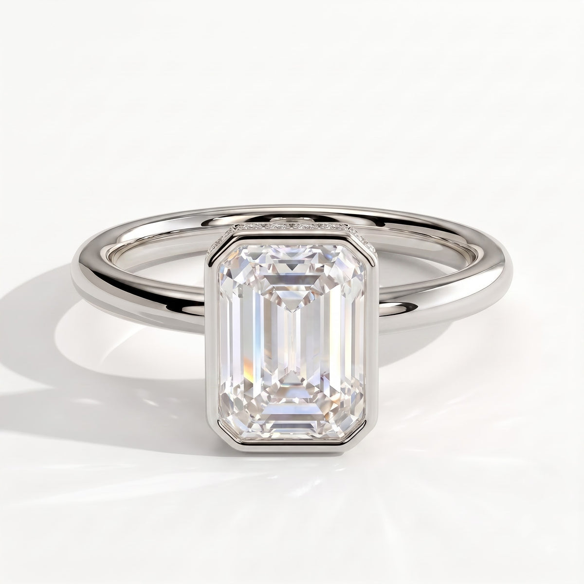 Emerald lab-grown diamond bezel-set halo engagement ring in 950 platinum, front view 