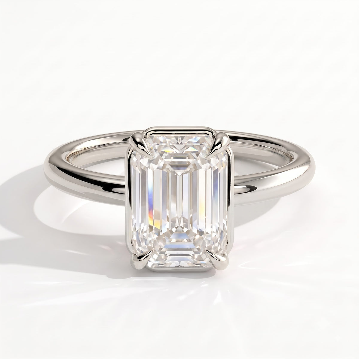 Emerald lab-grown diamond bezel-set solitaire engagement ring in 950 platinum, front view 