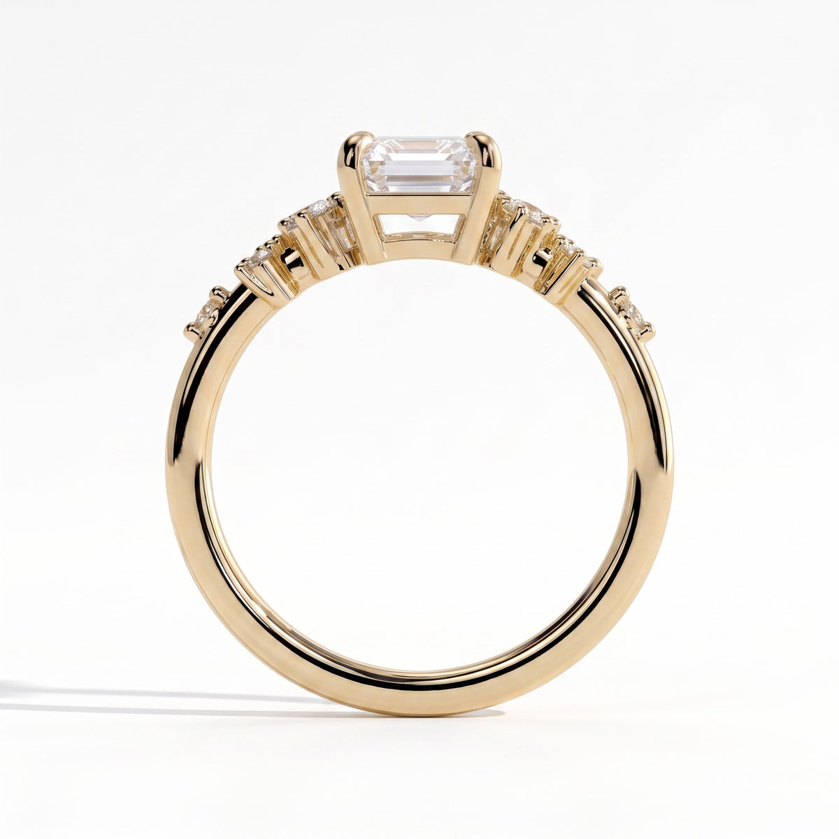 Emerald lab-grown diamond three-stone engagement ring in 18K (750) yellow gold, side profile 