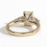 Emerald lab-grown diamond three-stone engagement ring in 18K (750) yellow gold, on white background 
