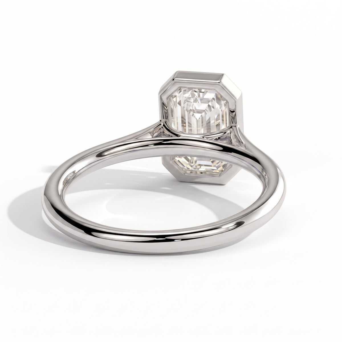 Emerald lab-grown diamond bezel-set solitaire engagement ring in 18K (750) white gold, on white background 
