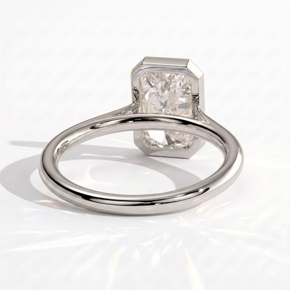 Radiant lab-grown diamond bezel-set solitaire engagement ring in 18K (750) white gold, on white background 