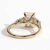 Radiant lab-grown diamond three-stone engagement ring in 18K (750) yellow gold, on white background 