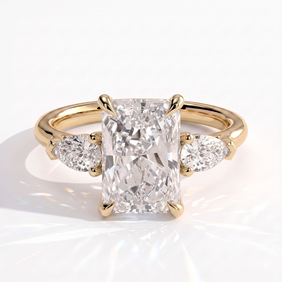 Radiant lab-grown diamond three-stone engagement ring in 18K (750) yellow gold, front view 
