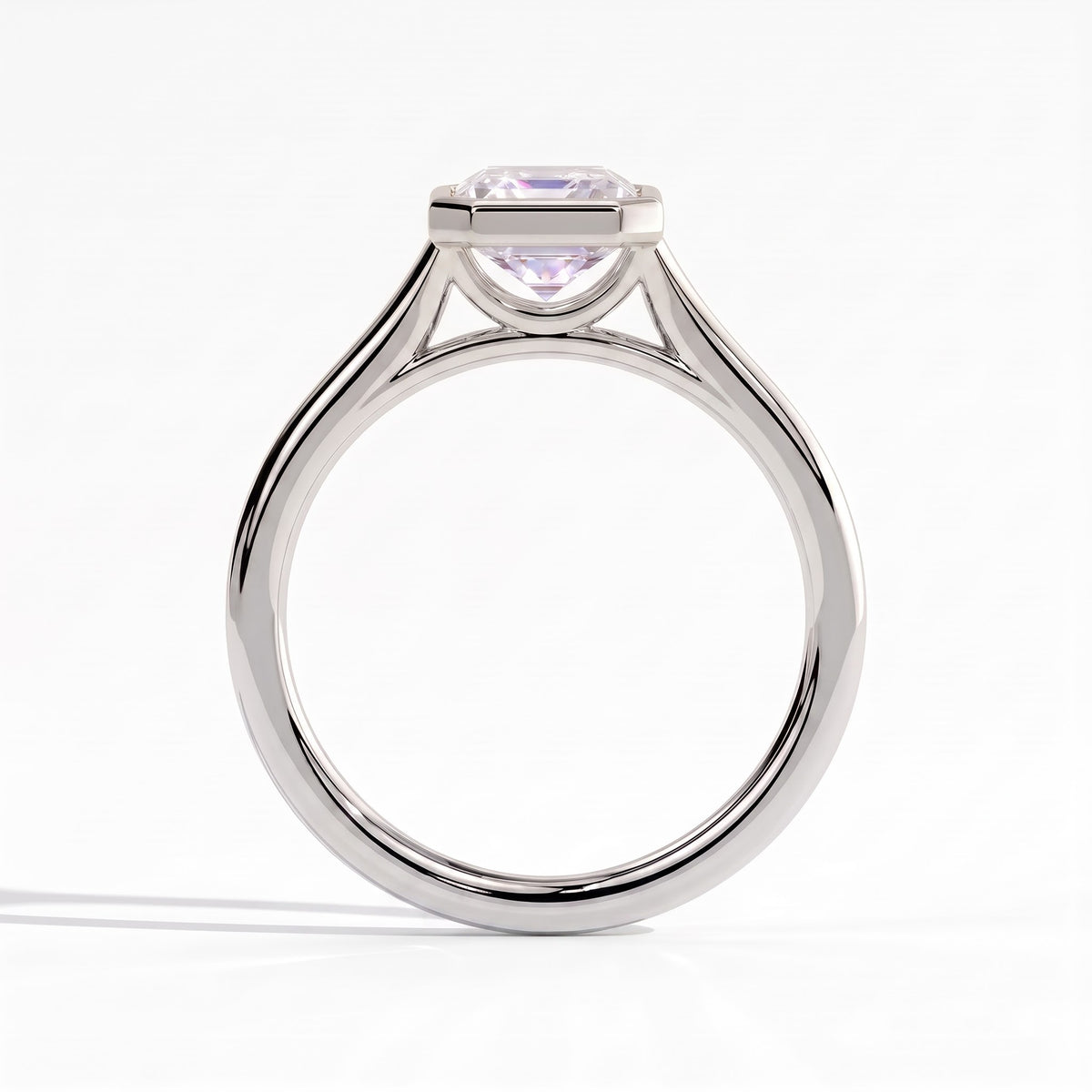 Emerald lab-grown diamond bezel-set solitaire engagement ring in 950 platinum, side profile 