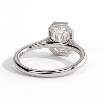 Emerald lab-grown diamond bezel-set solitaire engagement ring in 950 platinum, on white background 