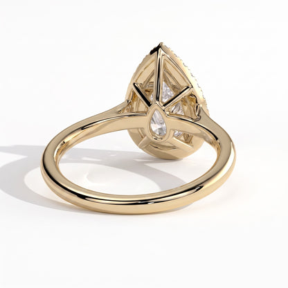 Pear lab-grown diamond halo engagement ring in 14K (585) yellow gold, on white background 