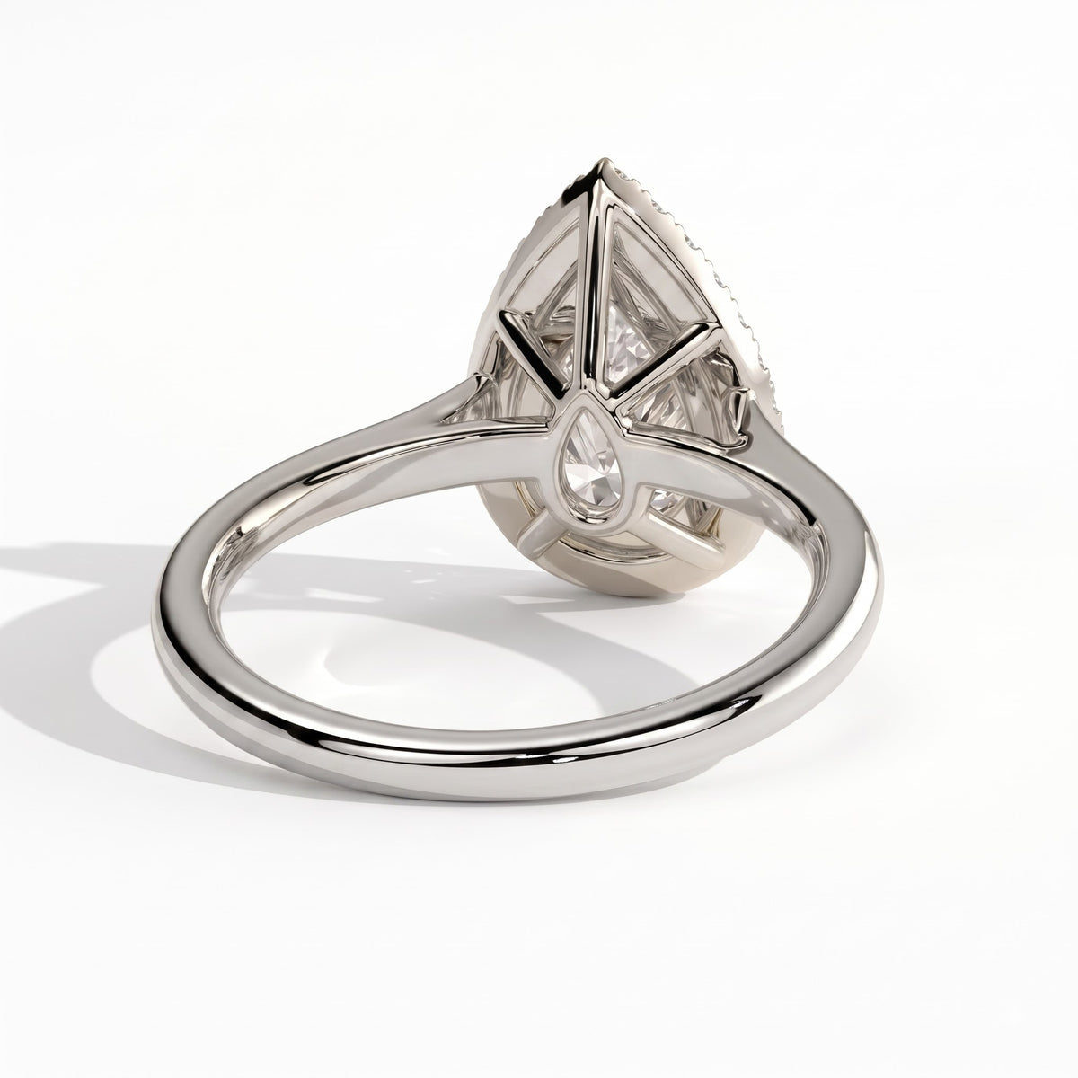 Pear lab-grown diamond halo engagement ring in 14K (585) white gold, on white background 