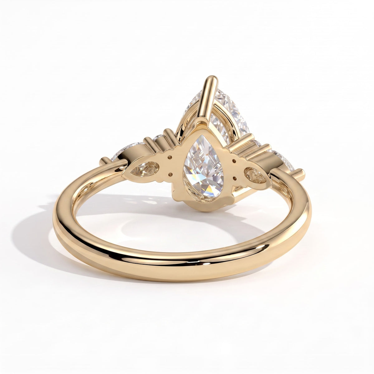 Pear lab-grown diamond halo engagement ring in 18K (750) yellow gold, on white background 