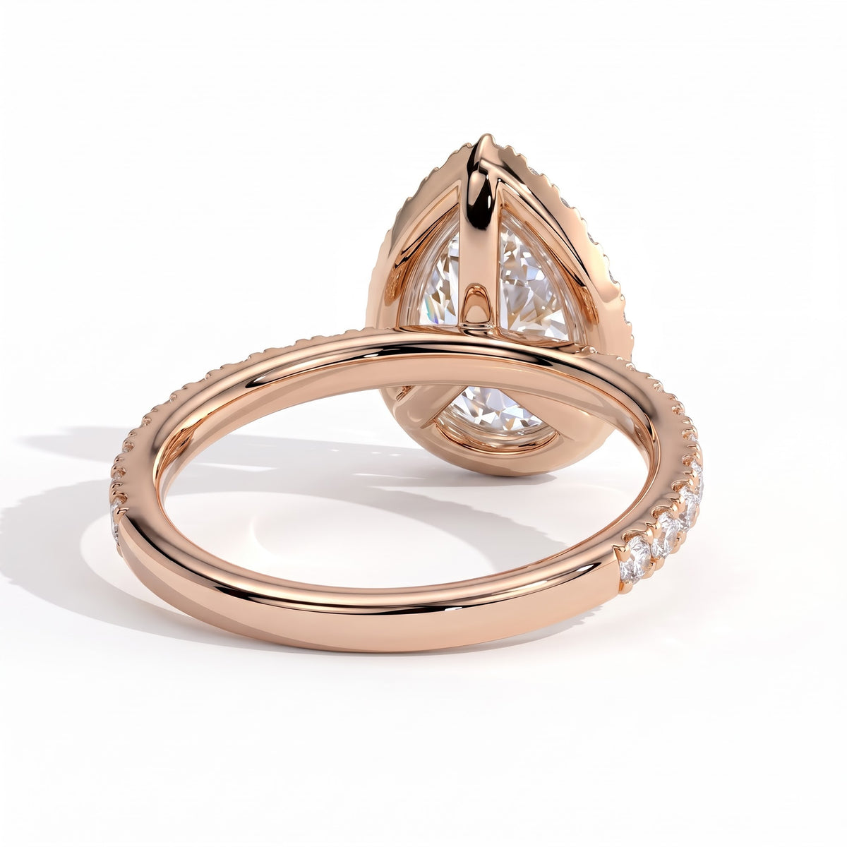 Pear lab-grown diamond halo engagement ring in 14K (585) rose gold, on white background 