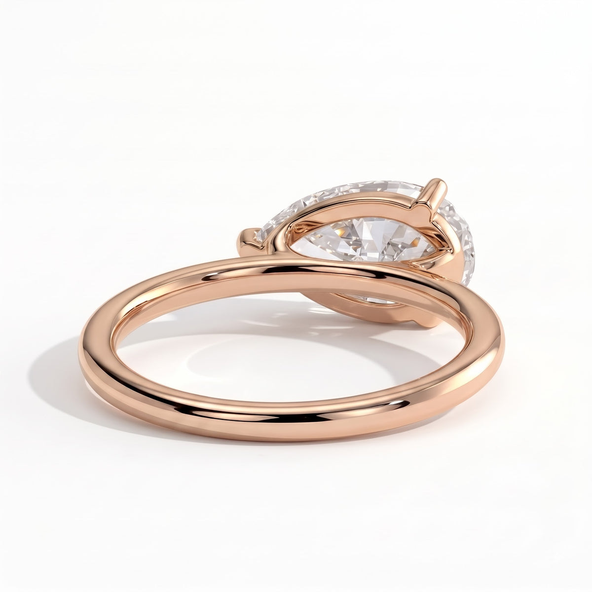 Pear lab-grown diamond east-west solitaire engagement ring in 14K (585) rose gold, on white background 