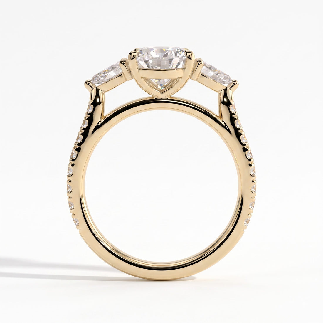 Pear lab-grown diamond three-stone engagement ring in 14K (585) yellow gold, side profile 