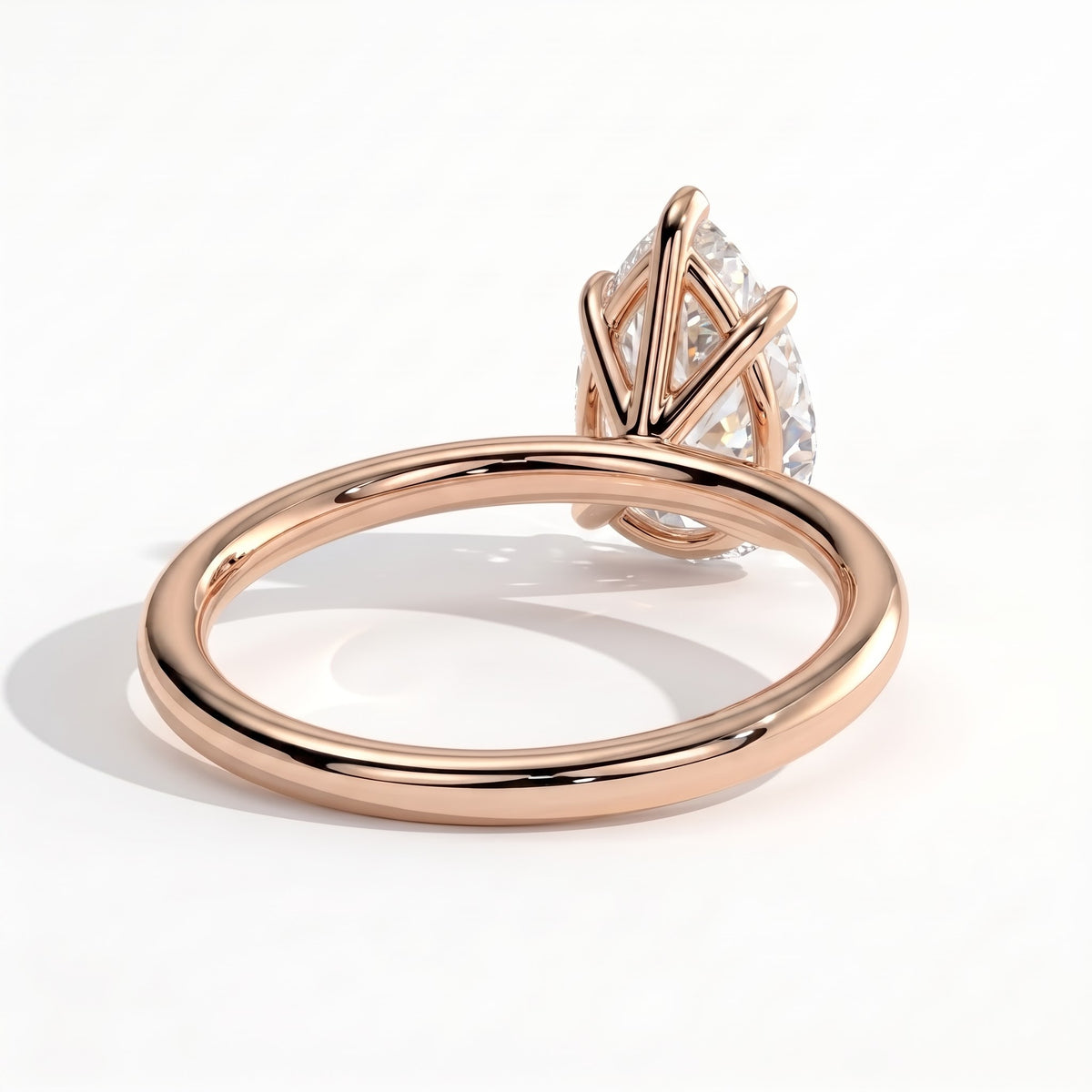 Pear lab-grown diamond solitaire engagement ring in 18K (750) rose gold, on white background 