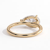 Pear lab-grown diamond east-west solitaire engagement ring in 18K (750) yellow gold, on white background 