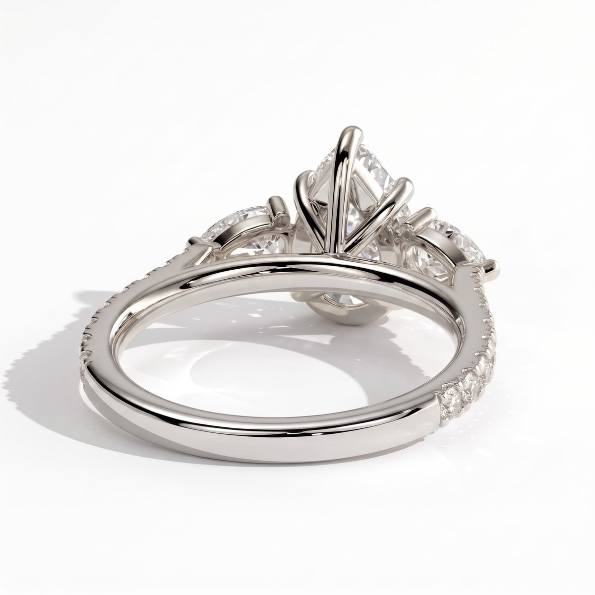 Pear lab-grown diamond three-stone engagement ring in 950 platinum, on white background 