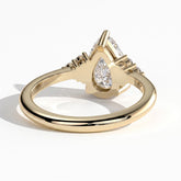 Pear lab-grown diamond halo engagement ring in 14K (585) yellow gold, on white background 