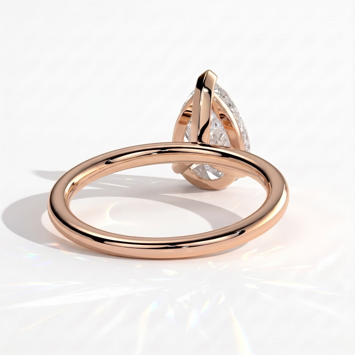 Pear lab-grown diamond solitaire engagement ring in 14K (585) rose gold, on white background 