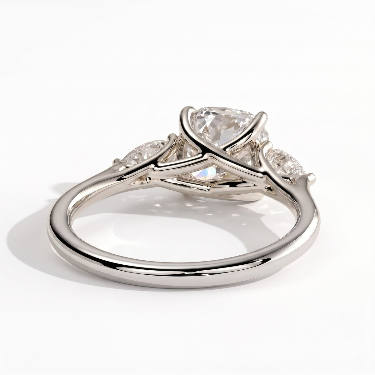 Cushion lab-grown diamond three-stone engagement ring in 14K (585) white gold, on white background 
