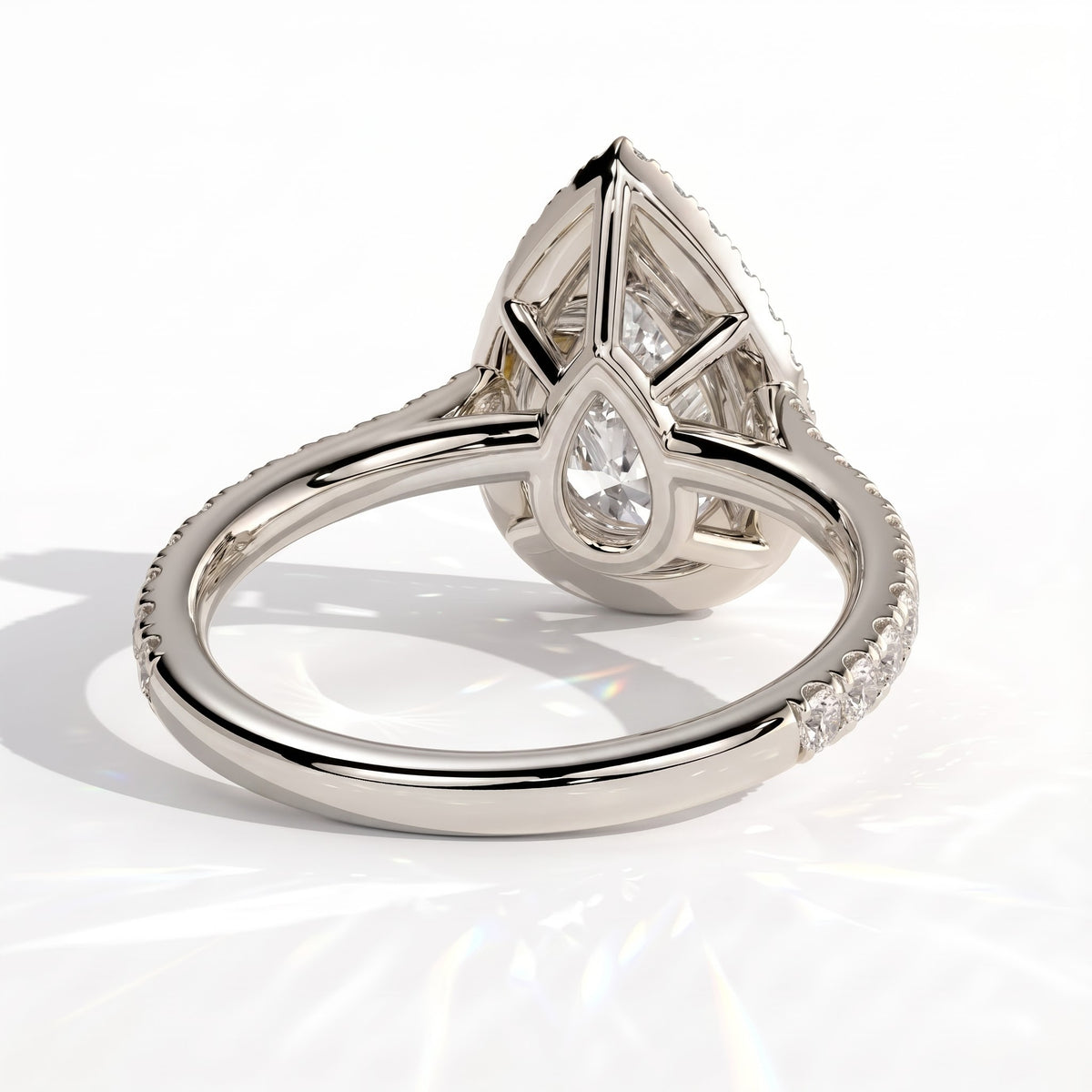 Pear lab-grown diamond halo engagement ring in 18K (750) white gold, on white background 