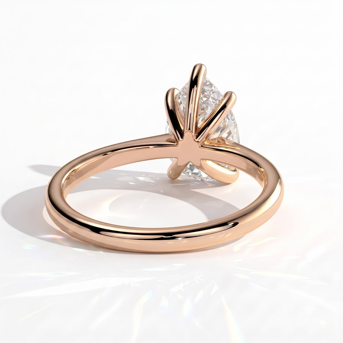 Pear lab-grown diamond solitaire engagement ring in 18K (750) rose gold, on white background 