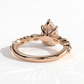Pear lab-grown diamond halo engagement ring in 18K (750) rose gold, on white background 