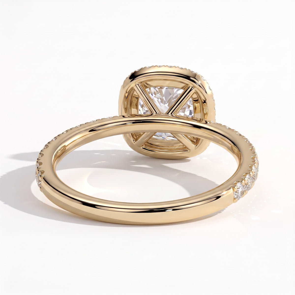 Cushion lab-grown diamond halo engagement ring in 18K (750) yellow gold, on white background 