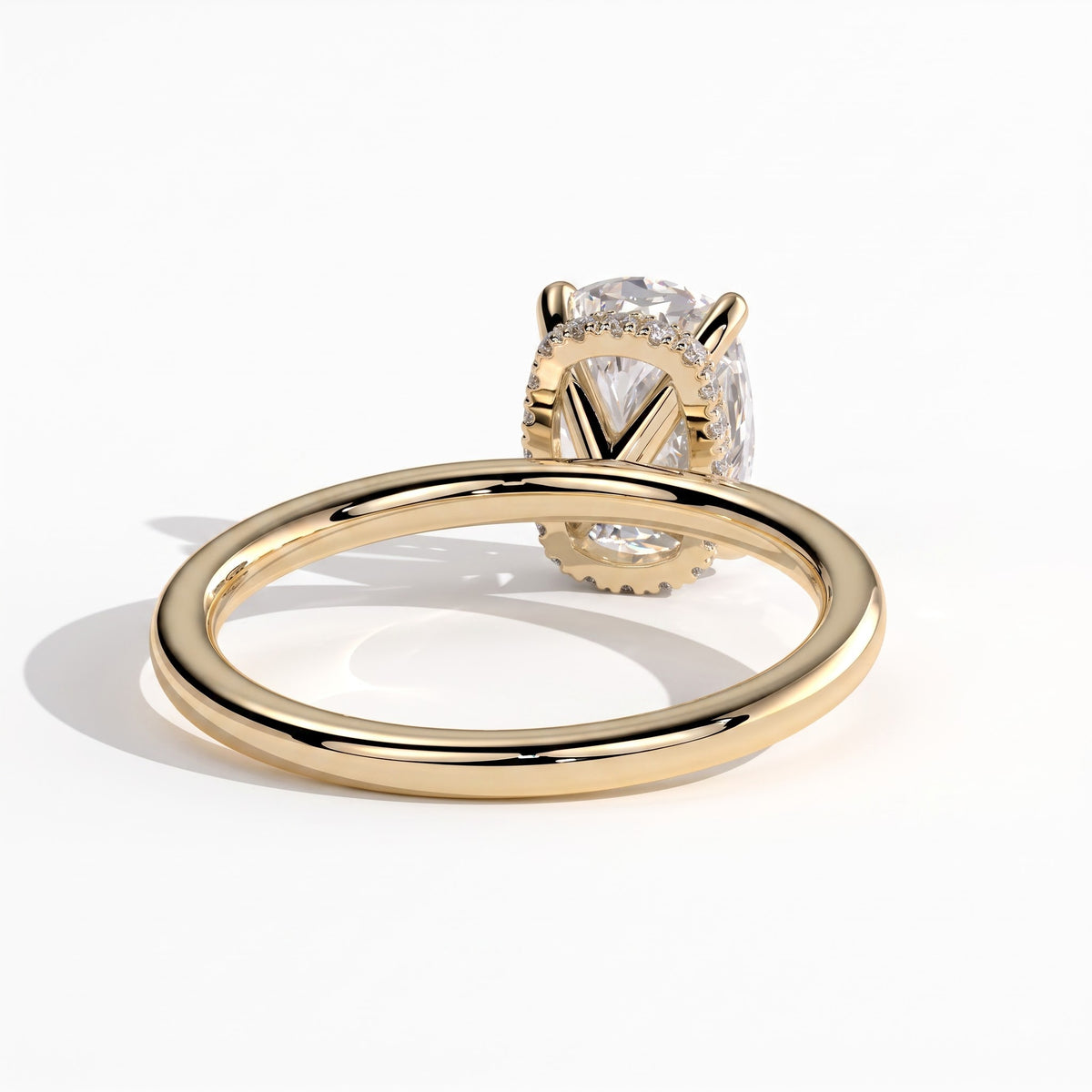 Elongated Cushion lab-grown diamond solitaire engagement ring in 14K (585) yellow gold, on white background 