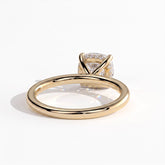 Cushion lab-grown diamond solitaire engagement ring in 18K (750) yellow gold, on white background 