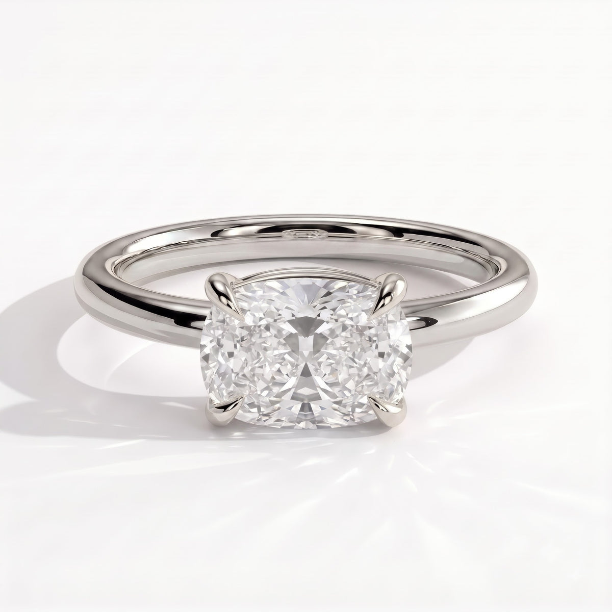 Elongated Cushion lab-grown diamond east-west solitaire engagement ring in 18K (750) white gold, front view 