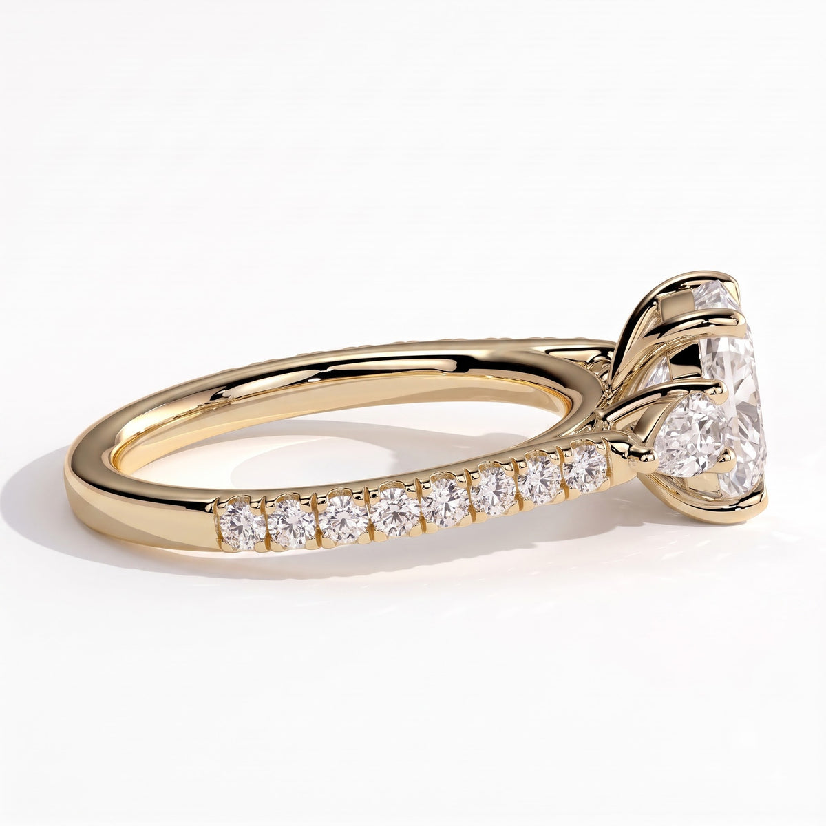 Elongated Cushion lab-grown diamond three-stone engagement ring in 14K (585) yellow gold, three-quarter view 